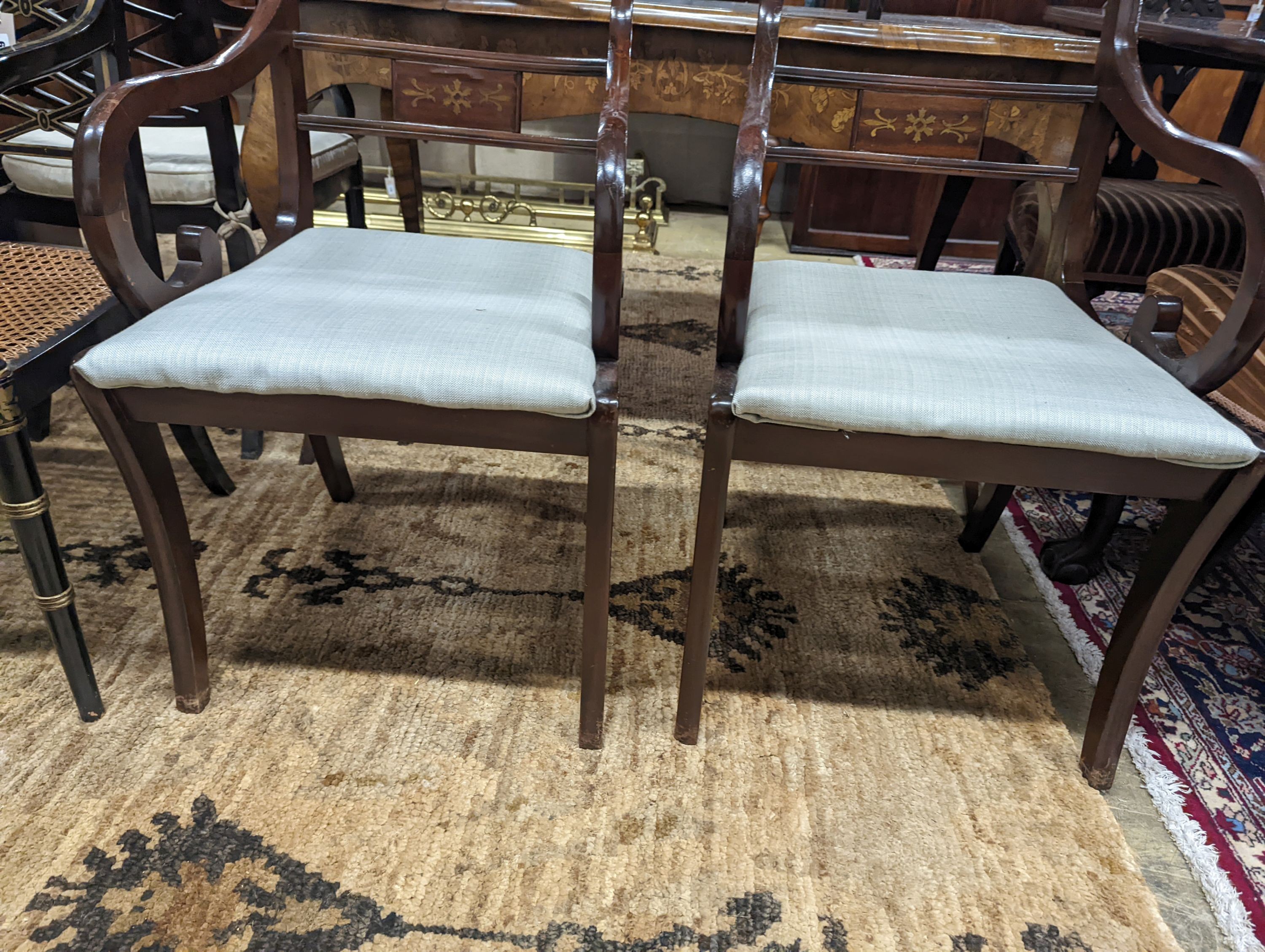 A pair of Regency style brass inlaid mahogany elbow chairs, width 48cm, depth 48cm, height 88cm
